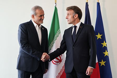French President Emmanuel Macron (R) and Iran’s President Masoud Pezeshkian (L) meet on the sidelines of the United Nations General Assembly in New York City Sept. 24, ahead of a UN Security Council decision to reimpose nuclear-related sanctions on Tehran. (Photo by Ludovic Marin/AFP via Getty Images)