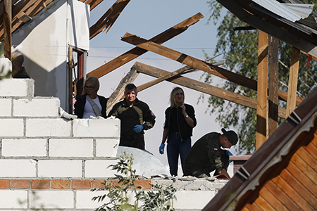 Police and army officials inspect damage to a house destroyed by debris from a Russian drone shot down Sept. 10 over the village of Wyryki-Wola in eastern Poland. NATO air defenses helped counter drones that Polish officials say violated Polish airspace overnight. (Photo by Wojtek Radwanski/AFP via Getty Images)