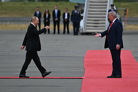 U.S. President Donald Trump (R) greets Russian President Vladimir Putin on the tarmac after they arrived at Joint Base Elmendorf-Richardson in Anchorage, Alaska, on August 15, 2025. (Photo by Andrew Caballero-Reynolds/AFP via Getty Images)