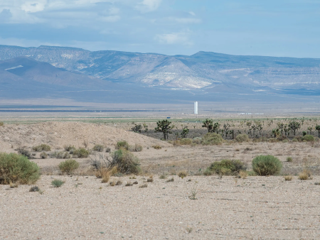 Beyond the crater formed by the “Divider” nuclear test, the last U.S. nuclear test explosion, is the tower for “Icecap,” a joint U.S.-UK nuclear test that was nearly ready to execute but never happened due to the congressionally-mandated nuclear testing moratorium enacted on October 3, 1992. (Photo by the Los Alamos National Laboratory)