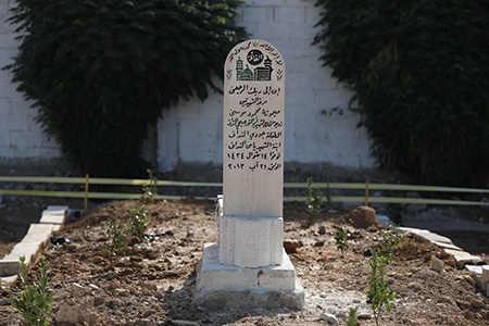 A gravestone with names of chemical massacre victims on August 21, 2025 in Zamalka, Syria. Twelve years earlier, President Bashar al-Assad ordered strikes on two opposition-controlled areas of Ghouta, unleashing the deadliest use of chemical weapons since the Iran-Iraq War. (Photo by Ali Haj Suleiman/Getty Images)