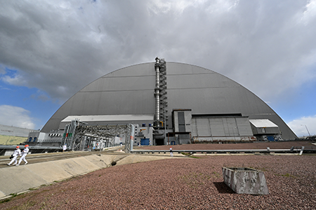 The United States announced it would contribute funds to repair damage done to the Chernobyl nuclear power plant. The repairs are necessary after the International Atomic Energy Agency assessed that the New Safe Confinement structure, built over the reactor after it melted down in 1986, sustained damage during a February 2025 drone strike.  (Photo by Sergei Supinsky/AFP via Getty Images)