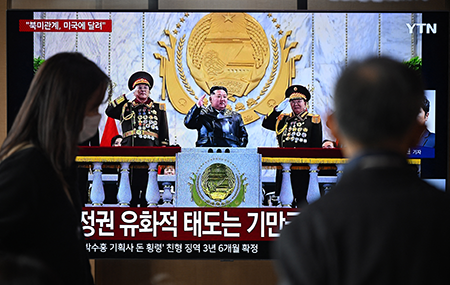 People in a Seoul railway station Feb. 26 watch a screen showing a news broadcast of North Korean leader Kim Jong Un attending the military parade in Pyongyong. Kim said North Korea could “get along well” with the United States if Washington acknowledges its nuclear status, but dashed hopes of a diplomatic thaw with South Korea, state media reported. (Photo by Jung Yeon-je / AFP via Getty Images)