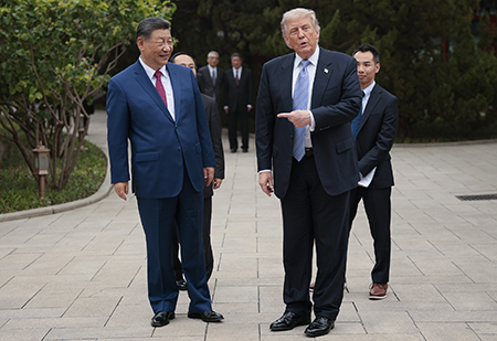 U.S. President Donald Trump gestures towards Chinese President Xi Jinping during a May 15 official visit to Beijing. Enroute back to Washington, Trump told reporters he presented Xi with a “denuclearization” proposal. (Photo by Evan Vucci - Pool/Getty Images)
