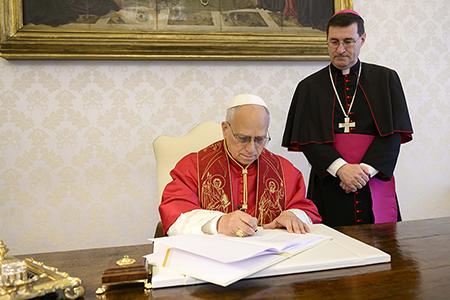 Pope Leo XIV signs Magnifica Humanitas at the Apostolic Palace in the Vatican. (Photo by Simone Risoluti, Vatican Media via Vatican pool/Getty Images)
