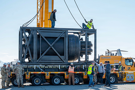 Civilian contractors secure rigging to a containerized nuclear power reactor during operations at March Air Force Reserve Base, California, in February 2026. The reactor was prepared for transport and scheduled for airlift aboard a C-17 Globemaster III to Hill Air Force Base, Utah. (Photo by Air Force Staff Sgt. Monica Bright)