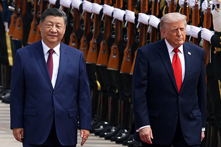 U.S. President Donald Trump (R), reviewing honor guard with Chinese President Xi Jinping in Beijing in May 2026, has gotten nowhere with his attempt to draw Beijing into multilateral nuclear arm control talks with Moscow and Washington. Trump will have another chance to make his case when the two men meet at the White House this month. (Photo by Alex Wong/Getty Images) 