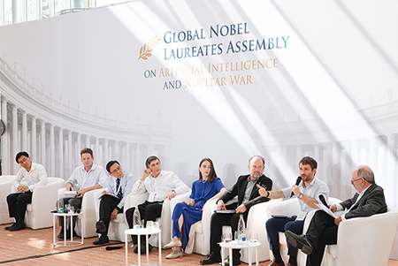 Panelists during a session on “The Use of AI in Nuclear Weapon Systems” on July 14, 2026. Left to right, Tong Zhao (Carnegie Endowment), Jason Pruet (OpenAI), Tatsujiro Suzuki (Nagasaki University), Andre Konstantin Geim (2010 Nobel Prize in Physics), Oleksandra Matviichuk (2022 Nobel Peace Prize), Daryl G. Kimball (Arms Control Association), Tristan Harris (Center for Humane Technology), and the moderator, John Mecklin (Bulletin of the Atomic Scientists).
