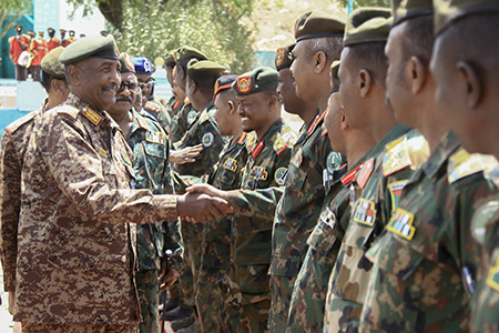 Sudan’s army chief, Abdel Fattah al-Burhan, greets military personnel on a visit to Gedaref state in 2024. The United States in June implemented additional sanctions on Sudan for allegedly using chemical weapons during fighting that occurred in 2024. (Photo by AFP via Getty Images)