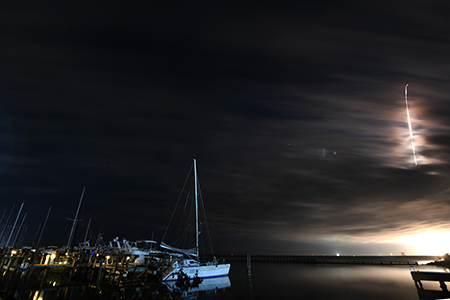 Sailboats rest in the water at Kennedy Point Park in Titusville, FL, as a Vulcan Rocket from United Launch Alliance lifts off from Cape Canaveral Space Force Station on February 12, 2026, carrying national security spacecraft that will go into geosynchronous orbit for the U.S. Space Force Space Systems Command on the USSF-87 mission. (Photo by Jim Watson / AFP via Getty Images)