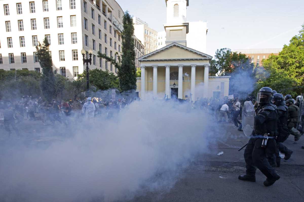  Police officers wearing riot gear push back demonstrators shooting tear gas next to St. John's Episcopal Church outside of the White House, June 1, 2020 in Washington D.C., during a protest over the death of George Floyd. (Photo by JOSE LUIS MAGANA/AFP via Getty Images)