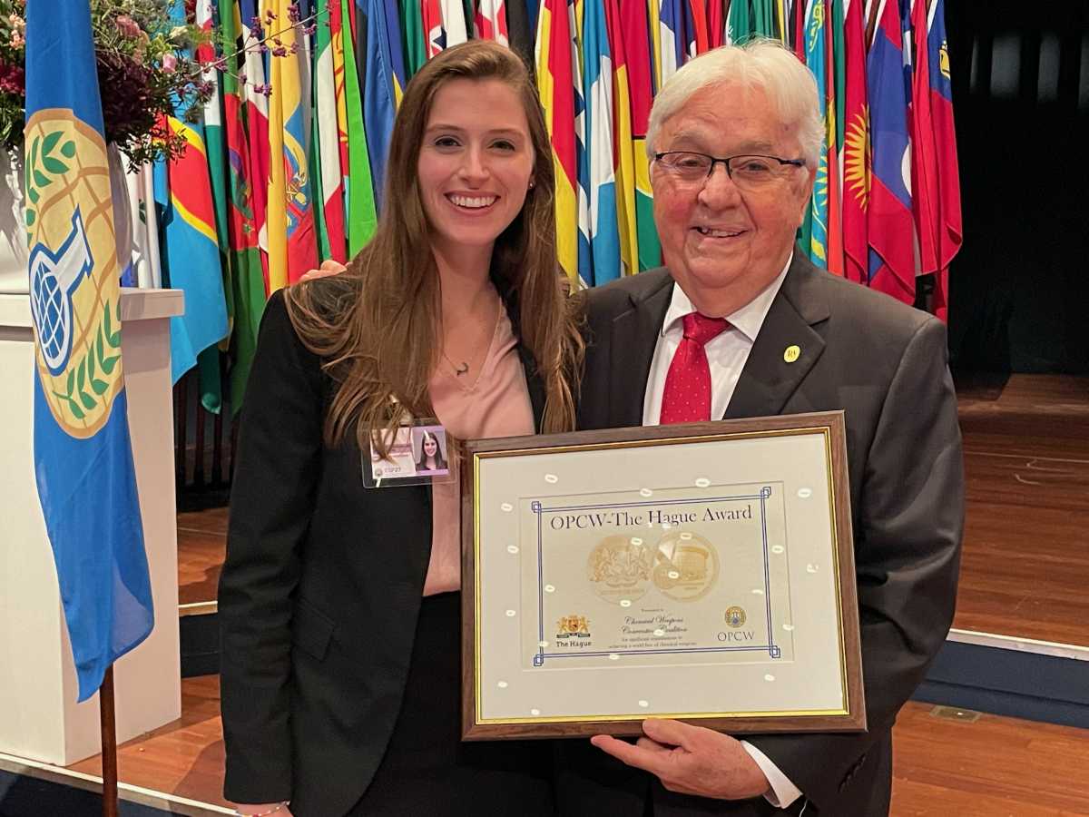 Program Coordinator Leanne Quinn and Chair Paul Walker accept the 2022 OPCE-The Hague Award on behalf of the the Chemical Weapons Convention Coalition.