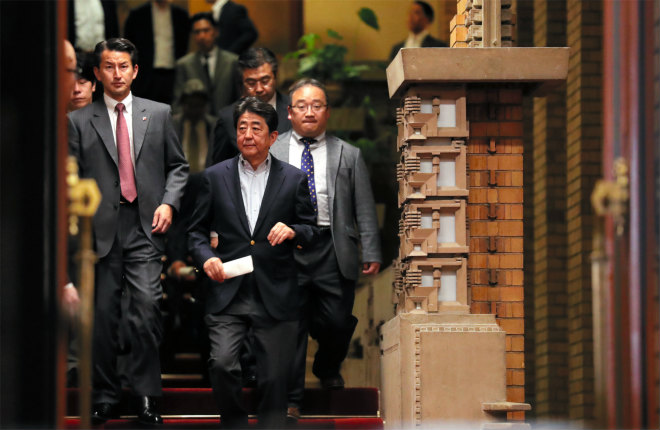 Prime Minister Shinzo Abe emerges with aides after finishing telephone talks with U.S. President Donald Trump on the night of May 6, over North Korea’s firing of projectiles on May 4. (Photo: Shiro Nishihata)