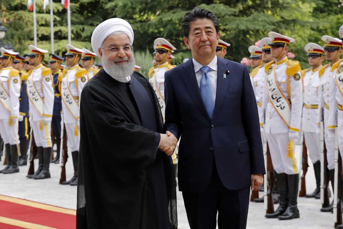 Iranian President Hassan Rouhani (L) welcomes Japanese Prime Minister Shinzo Abe, during a welcoming ceremony at the Saadabad Palace in the capital Tehran on June 12, 2019.  (Photo:STRINGER/AFP/Getty Images)