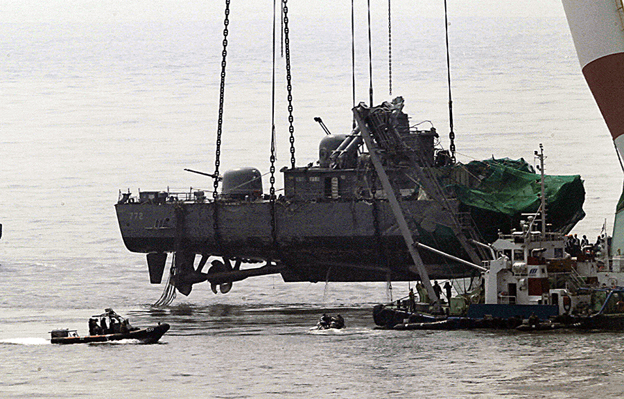A giant floating crane lifts a South Korean warship to place it on a barge in April 2010. The 1,200-ton corvette Cheonan was split in two by an external explosion on March 26 near a disputed Yellow Sea border, with the loss of 46 lives. Seoul blames Pyongyang. (Photo by Hong Jin-Hwan/AFP via Getty Images)