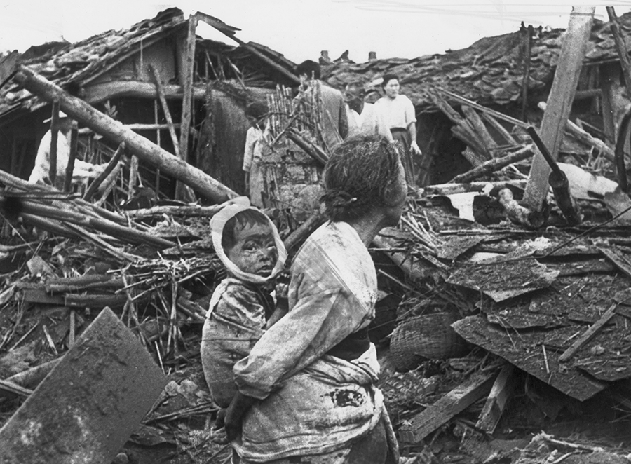 An elderly woman and her grandchild wander among the debris of their wrecked home in the aftermath of an air raid by U.S. planes over Pyongyang during the 1951-1953 Korean War. The conflict is part of a legacy of grievance and heartbreak that continues to shape relations between North and South Korea. (Photo by Keystone/Getty Images)